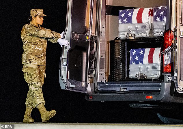 Door Attendant Staff Sergeant Siannie L. Concepcion closes the door of the transport vehicle carrying the transfer cases of three military members killed