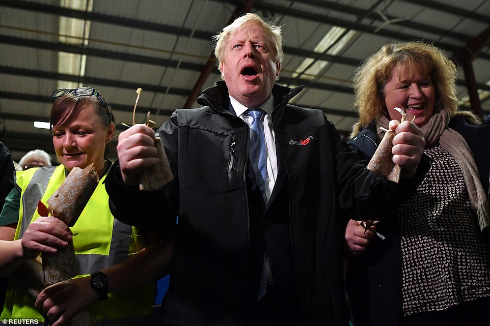 Mr Johnson appeared to be in good spirits as he visited a wrapping paper factory where he pulled Christmas crackers with staff