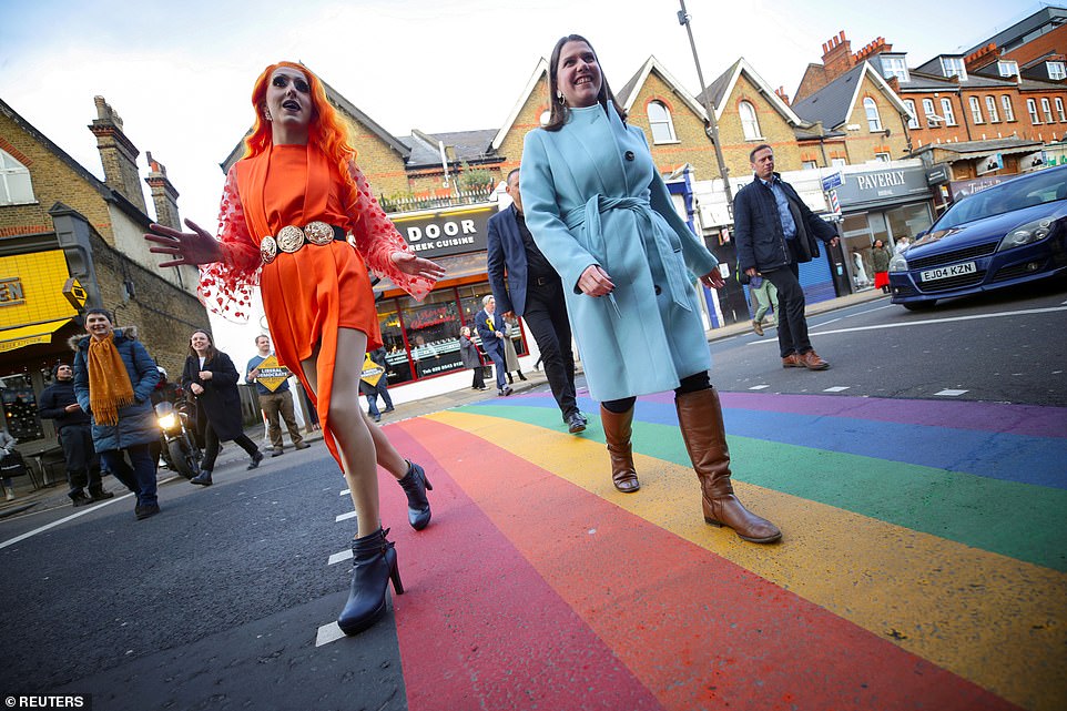 Jo Swinson (pictured with drag artist Rosie Zinfandel) campaigns in Wimbledon as her party continues to slide in the polls