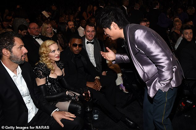 George watches on as Lang Lang speaks with Madonna at the Grammys in 2015