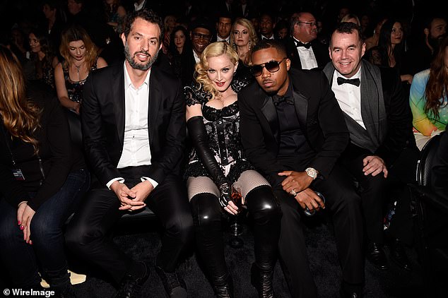 George is seen dressed to the nines again at the 2015 Grammys alongside (from left) manager Guy Oseary, Madonna and rapper Nas