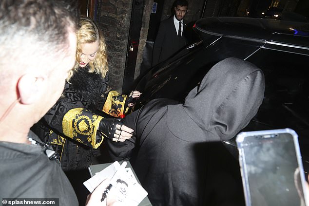 Superstar: The songstress was swarmed by fans as she left via the stage door