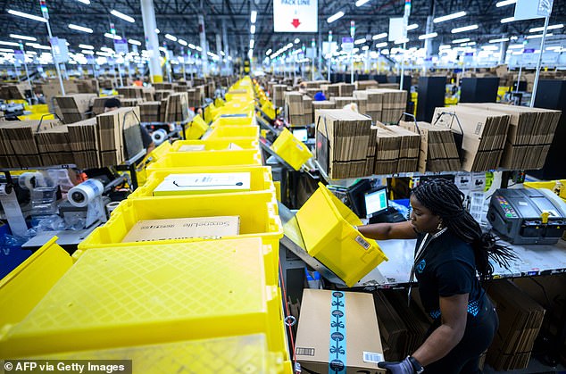 A woman working at a packing station. Some employees have complained of having their productivity constantly monitored by computers