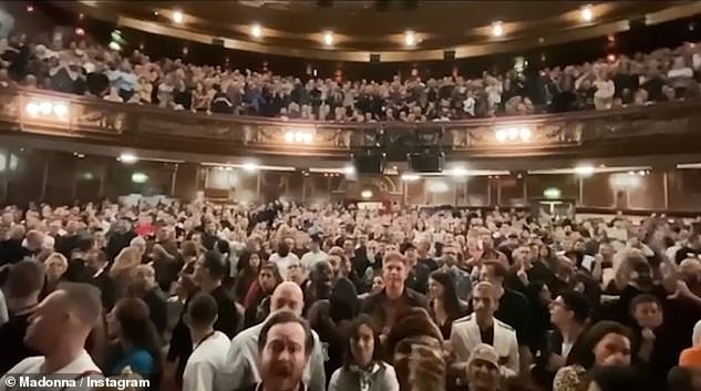 Loving life: Madonna's fans looked delighted as she burst through the curtain to keep performing, despite the fact she'd been cut off