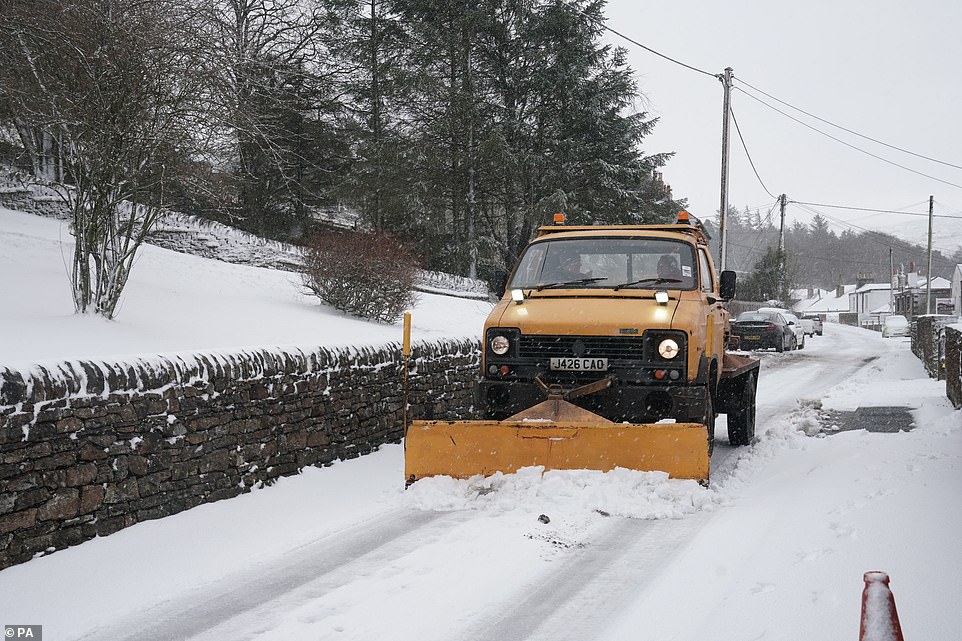 A snow plow clears a road in Nenthead, Cumbria. The scene looks post card perfect and the snow blanketed the area