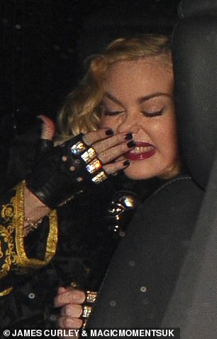 Going home: Madonna itched her nose as she sat in the back of her waiting car