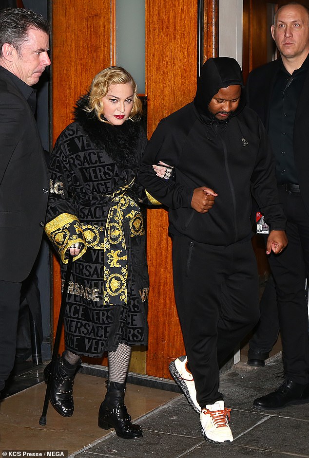 Weary: The night prior, the singer, 61, emerged from the arena in a Versace robe and held onto her burly security guard for support as she headed down the steps