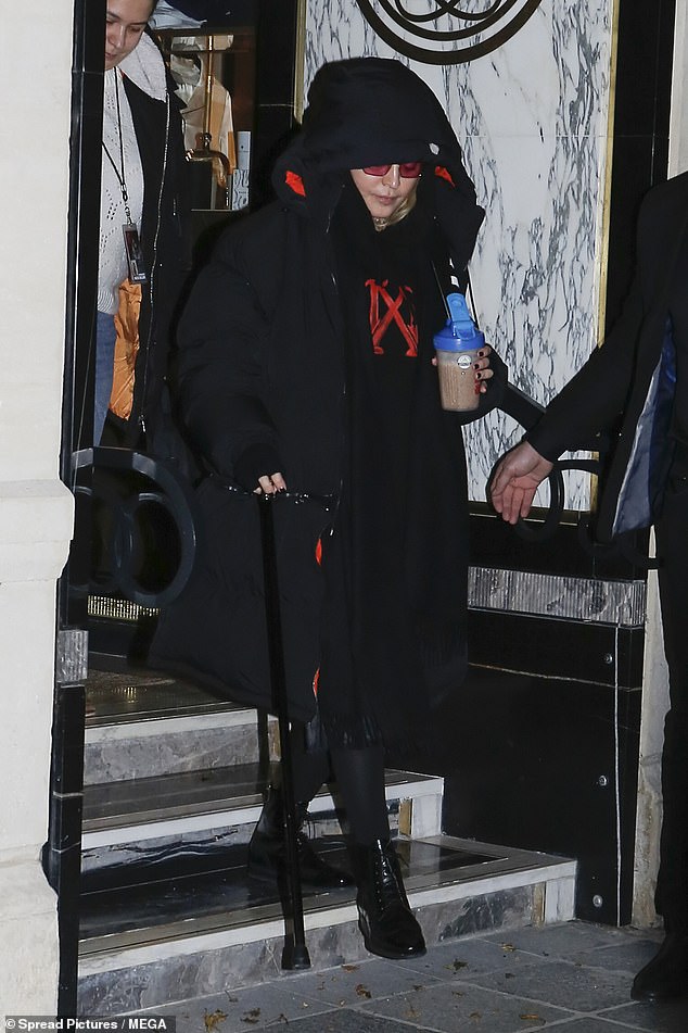 Madonna, who is still recovering from a nasty knee injury, held onto her trusty cane as she left Le Grand Rex in Paris on Thursday after another energetic show