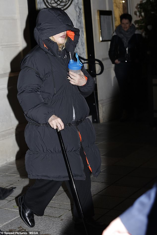 Sighting: Madonna covered up in a hooded jacket as she leaned on a cane during an outing in Paris on Saturday, two days after she struggled to continue her Madame X show at Le Grand Rex