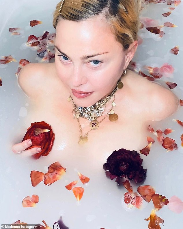 Reckless: Madonna stoked outrage in an earlier video from late March in which she called the coronavirus 'the great equalizer' while appearing to bathe nude in a milk bath filled with flower petals