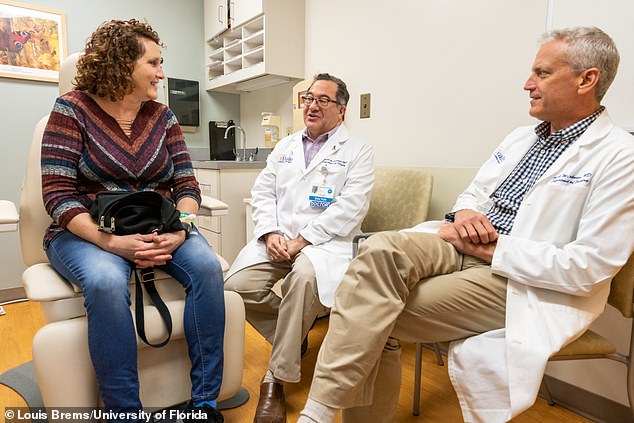 Terri was declared a perfect match and the transplant was performed in March 2020, a week before the coronavirus outbreak was declared a pandemic. Pictured: Terri (left) with the two surgeons, Dr Kenneth Andreoni (center) and Dr Mark Johnson (right) before the procedure