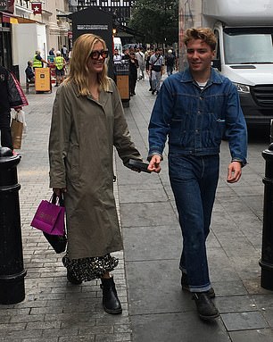 Stylish: She wore monochrome polka-dot trousers underneath the outerwear, and opted to match Rocco by boosting her height in a pair of black boots