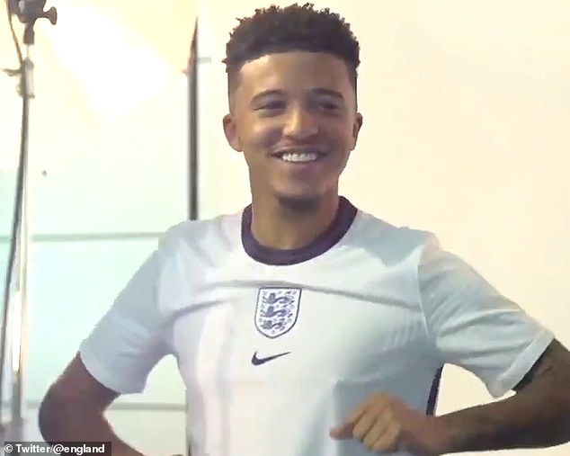 Jadon Sancho sports the home kit with a round collar and the England badge below