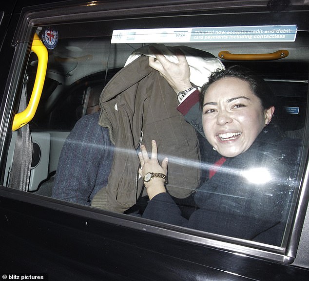 Night out: The art student, 20, cut a dapper figure in a charcoal pinstripe suit as he joined a female companion and other pals for a fun evening a day before the UK was plunged into a second national lockdown