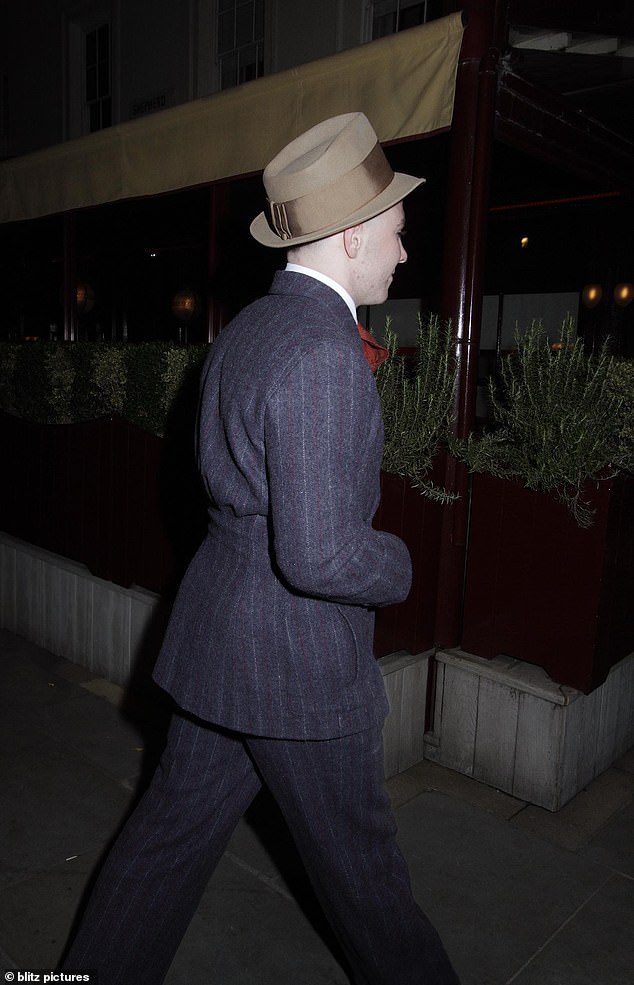 Looking good: Echoing his famous mother's sense of style, he teamed his suit with a crisp white shirt, red tie and a brown trilby hat