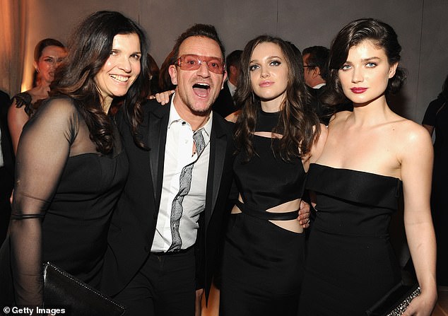 Here they come: She is the daughter of rock star Bono and businesswoman Ali Hewson (Eve with her mum Ali, dad Bono and sister Jordan in 2014)