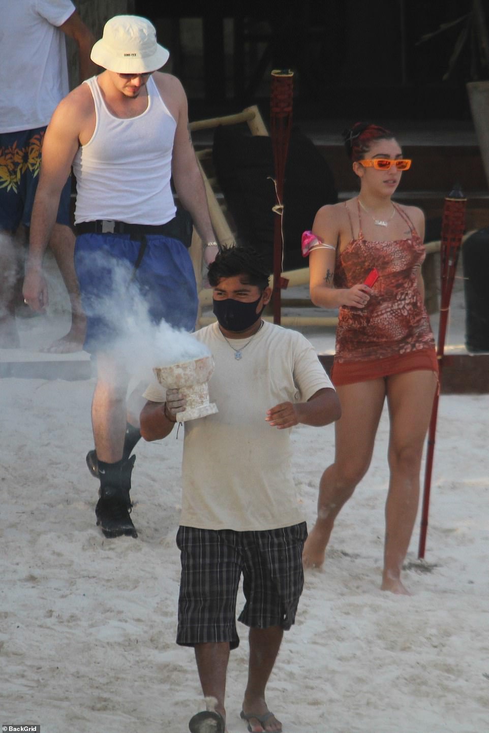 Short and sweet: Jonathan popped on a bucket hat, blue swim shorts and a black sneakers with high socks for a contemporary look