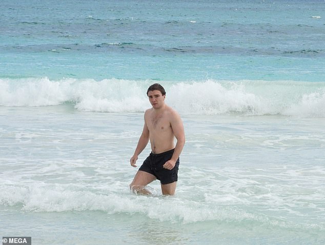 Time for a dip: After stripping off his T-shirt, the actor headed for a swim in the sea