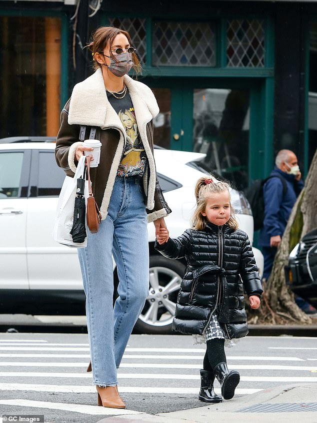 Cute: Meanwhile, little Lea looked quite the fashionista in a black padded jacket, white lace skirt and black patent boots