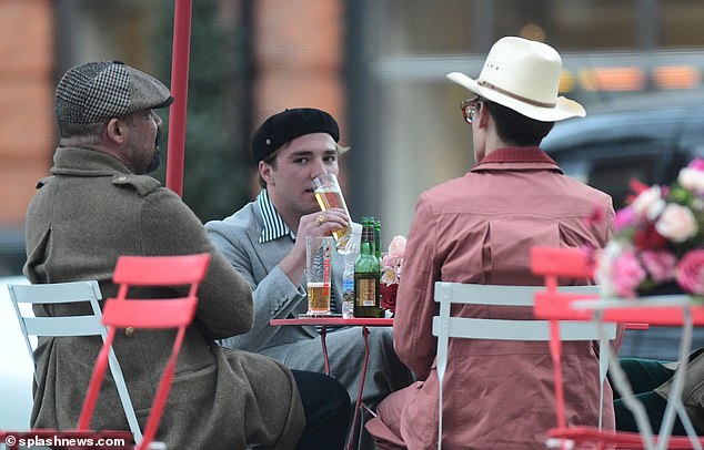 Out and about: The celebrity offspring was joined by two equally sharp dressers as he enjoyed his business meeting and catch up in the capital