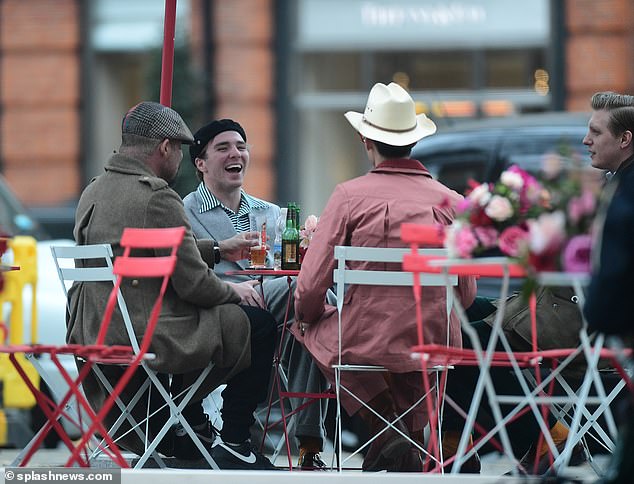 Laughs: Ritchie looked like he was having a great time enjoying a drink with his friends at the bar