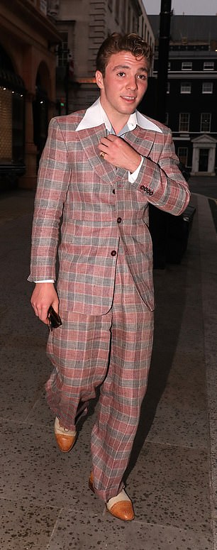 Rock on: The 20-year-old son of singing icon Madonna and director Guy Ritchie looked suave and sharp in a red and green checked two-piece suit, worn over a patterned shirt