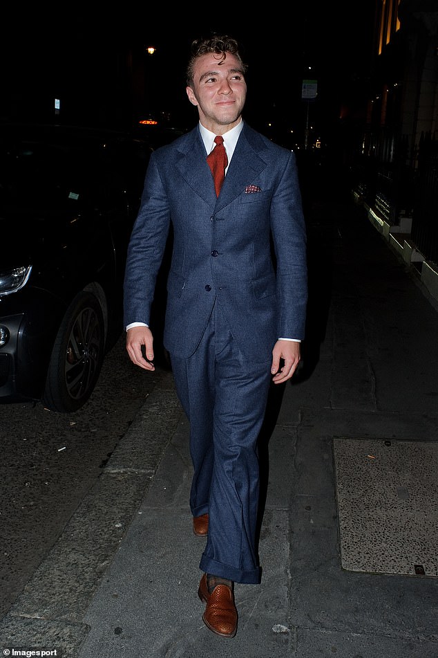 Smirking: The 20-year-old son of Madonna sported a classy blue two-piece suit as he left the venue in the capital at the end of the night