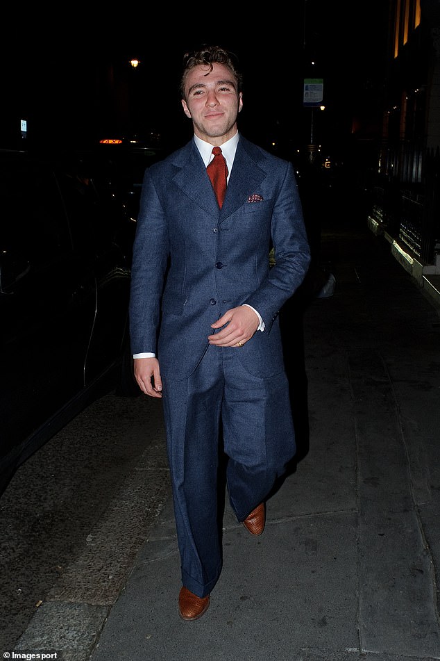 Stylish: Rocco Ritchie looked suave in a blue suit and brown leather shoes as he left Oswald's private members' club on Thursday night