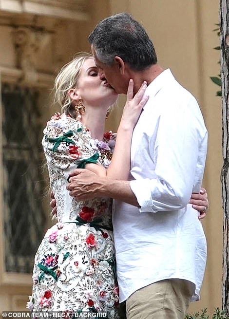 The newly-weds shared a sweet kiss as Kitty donned yet another Dolce & Gabbana number for the second day of her nupitals
