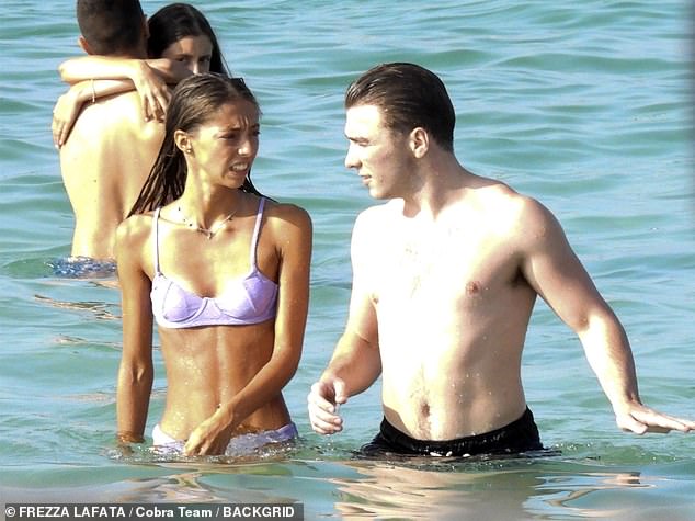 Hot new couple: The shirtless star displayed off his buff torso in just black swim shorts