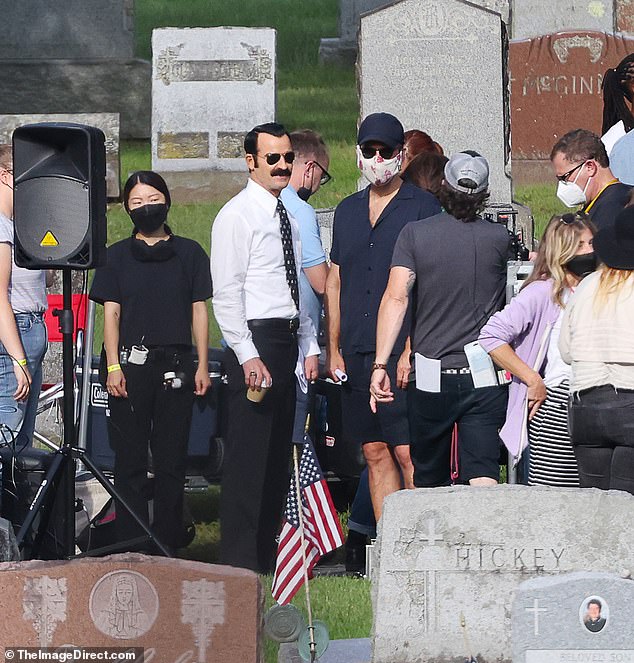 Setting the scene: Filming appeared to be done at a cemetery, where Justin was pictured standing amongst tomb stones with other crew members