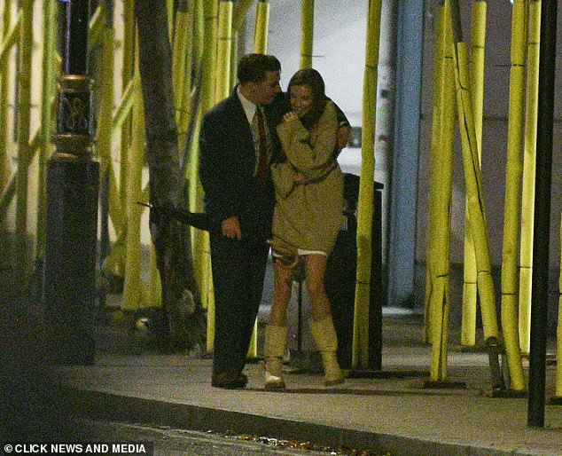 Smitten: Rocco Ritchie put his arm around a mystery brunette during a romantic stroll in the early hours of Saturday morning in London after a night out