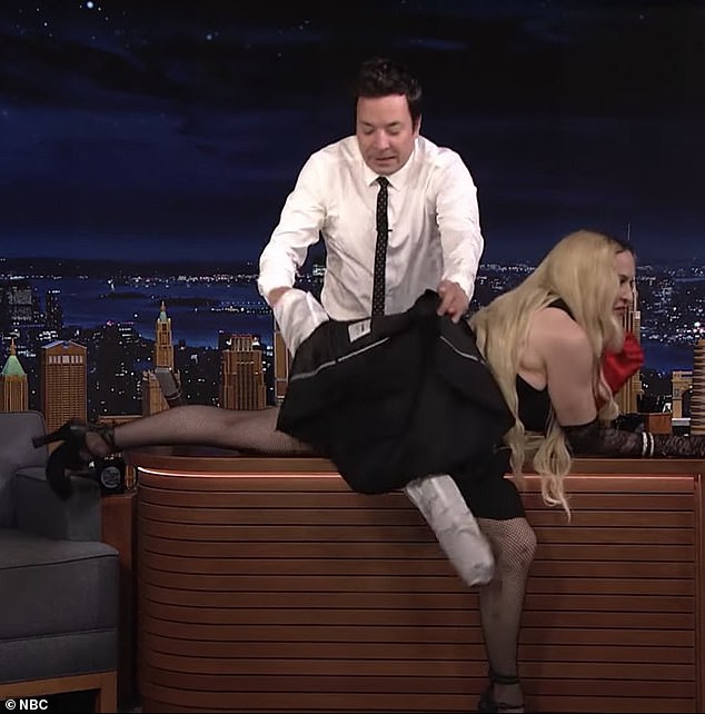 Oops: In a bid to protect her modesty, Jimmy leapt up screaming 'No! Madonna! Stop it! I don't know what to do. Stop it right now,' before removing his jacket and placing it across Madonna