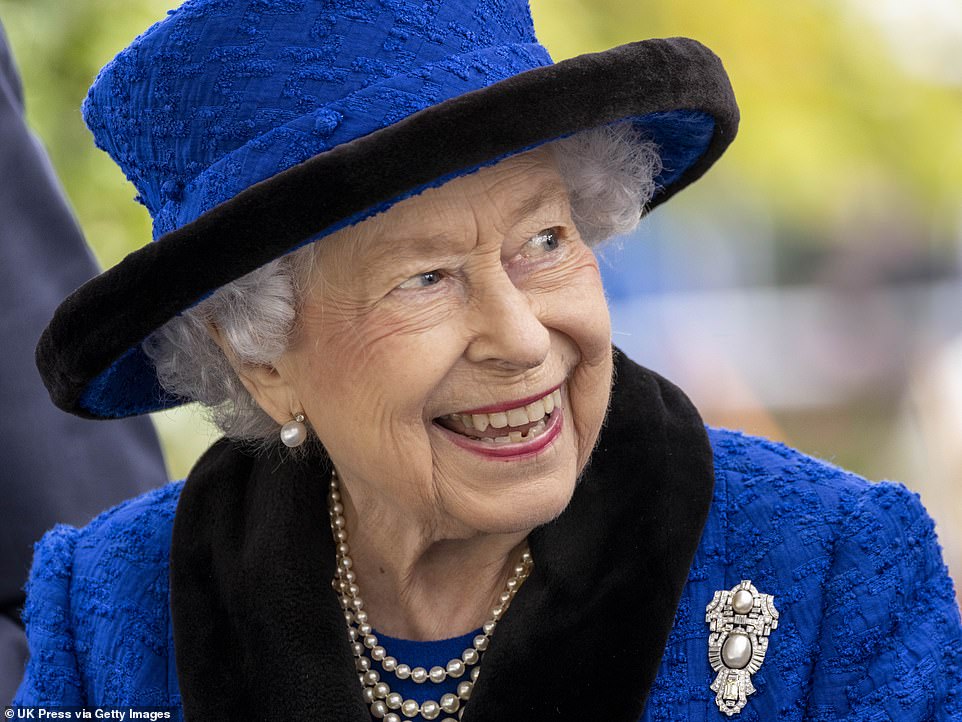 Her Majesty fended off the colder weather with a pair of black gloves and wore sensible, mid-height heels ahead of the busy day at Ascot, which is described as one of the 'most prestigious events in the British sporting calendar'.