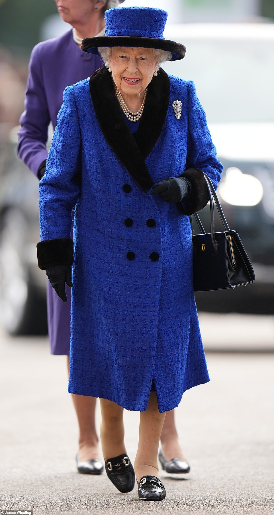 The Queen looked radiant in a traditional blue ensemble as she arrived at Ascot racecourse on Saturday to enjoy the QIPCO British Champions Day