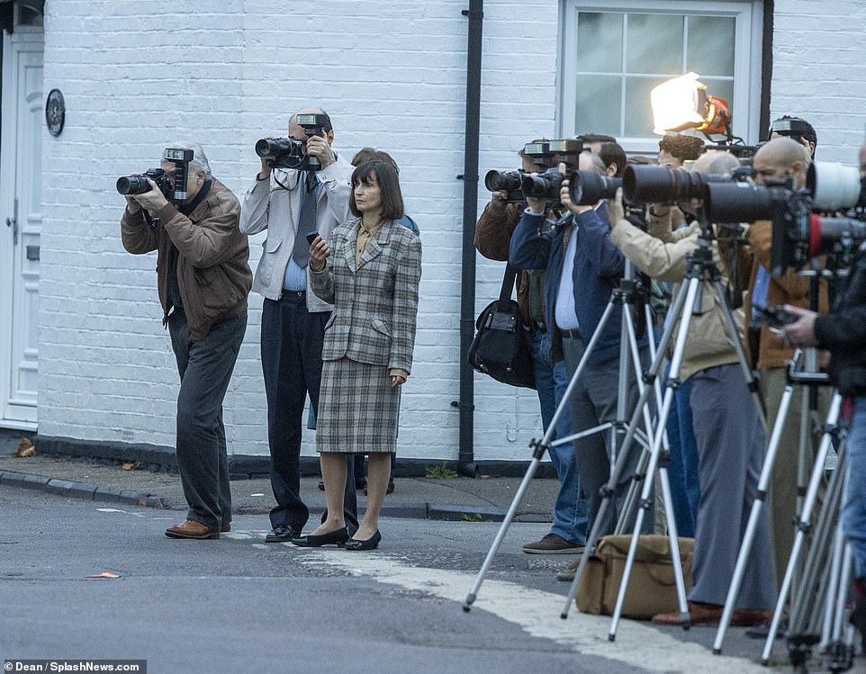 Media buzz: Production enlisted a huge cast of photographers and journalists as they family walked to the polling station