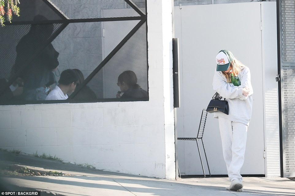 Making their exit: Jade waited for Elordi to gather his belongings as she stood outside the cafe