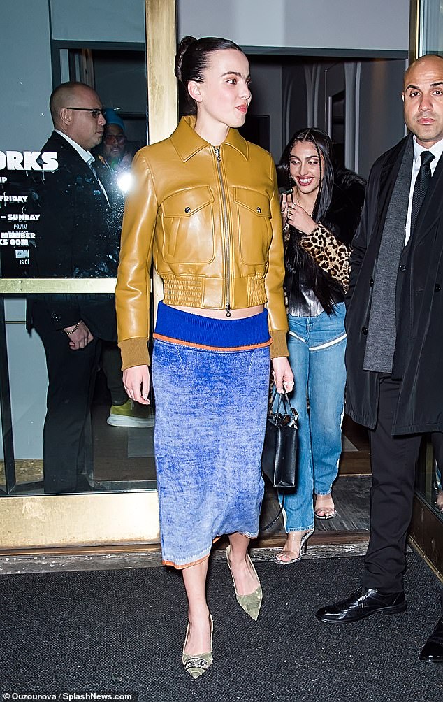 Gorgeous: She put her best fashion foot forward in a pair of khaki camouflage pumps and slipped her toned legs into a faded blue midi skirt