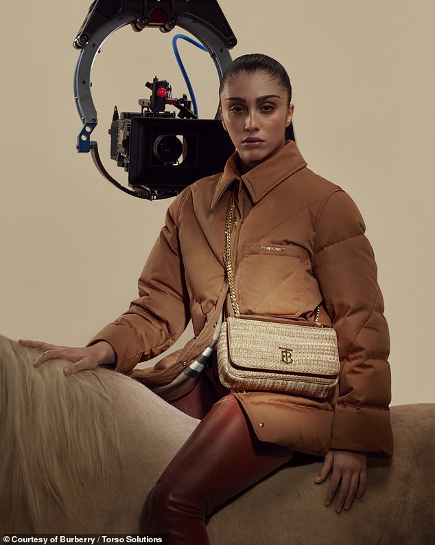 Looking good: Elsewhere in the campaign, Lourdes wrapped up in a brown Burberry coat, teamed with a pair of burgundy leather trousers while showcasing a tweed style of the bag