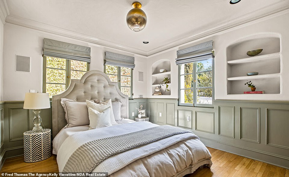 An ensuite guest bedroom with the original wainscoting can also be found on this floor.