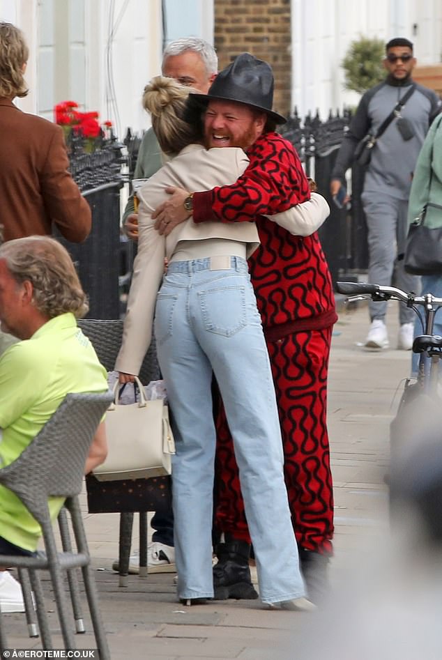 Reunited: Leigh - whose stage name is Keith Lemon - looked in good spirits as he gave Ashley a hug outside the pub