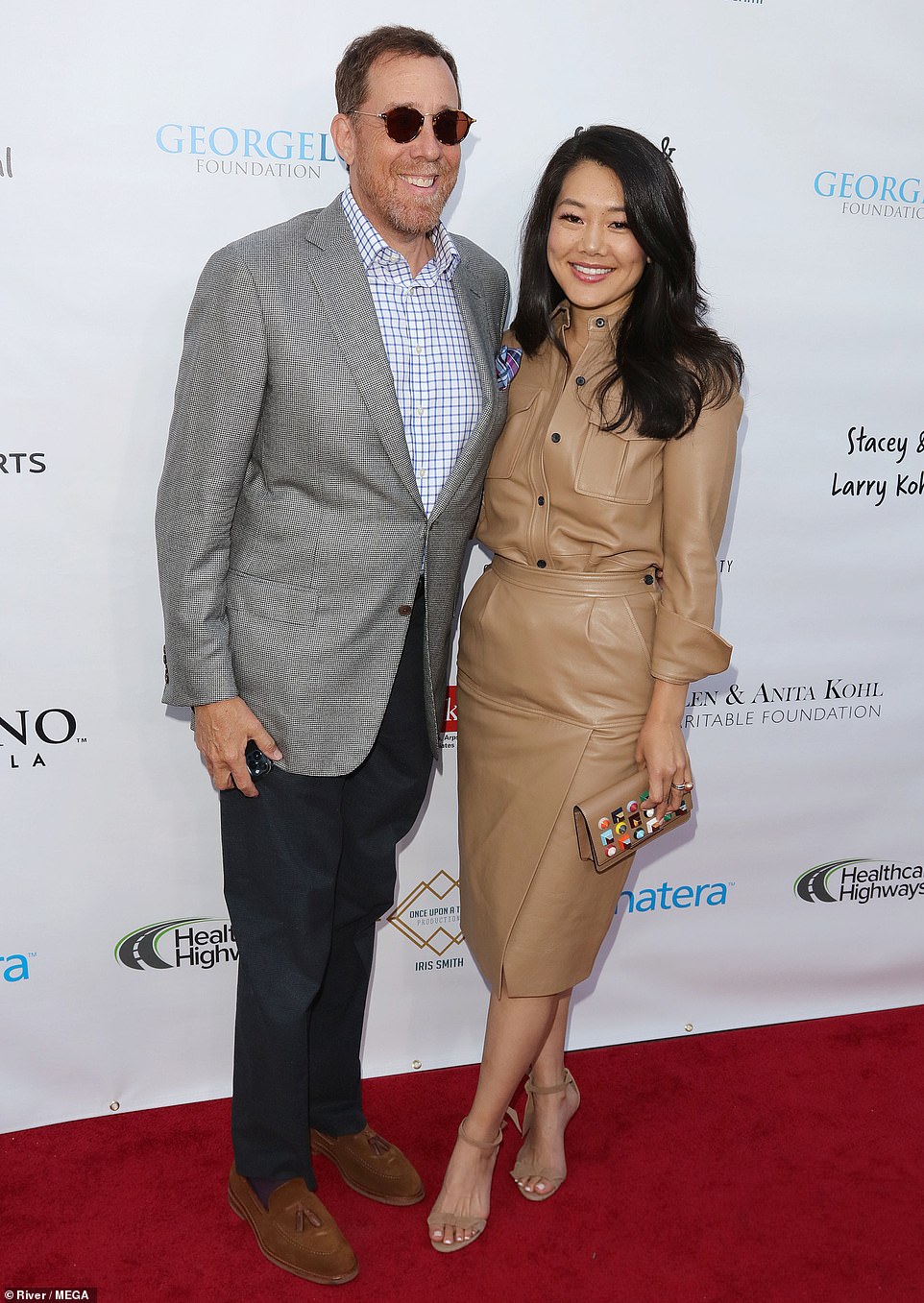 Cute couple: Rob Mingkoff wore a light gray jacket on top of a checkered shirt and black trousers while spending time with his wife Crystal