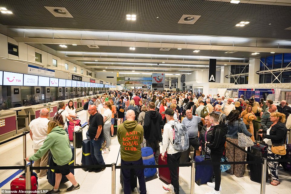 MANCHESTER AIRPORT - Passengers queue for check-in at Manchester Airport's Terminal 2 today as airport chaos continues