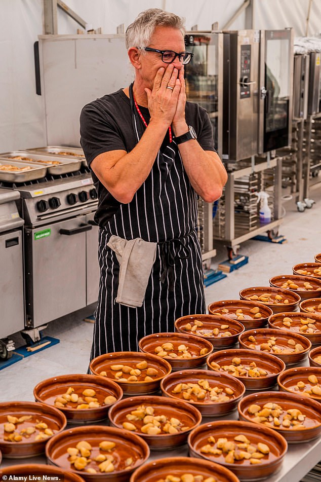 The former England ace covers his face with his hands as he looks on at his Catalan-themed creations