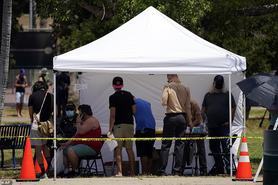 Pictured above are men queuing to get the monkeypox vaccine in Encino, California. It is being rolled out to the group as this is where the most cases have been detected