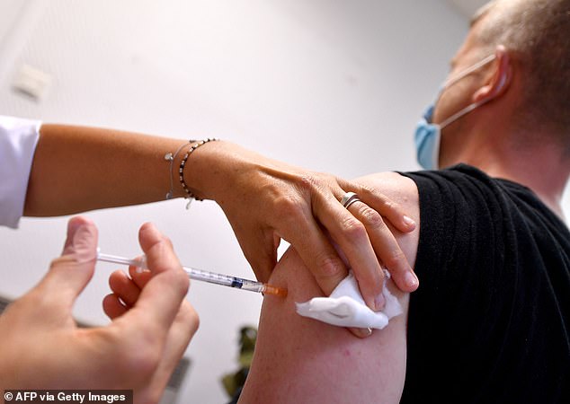 Experts have warned the monkeypox vaccine campaign is faltering. Pictured is a man being vaccinated against the disease in Lille, France, today