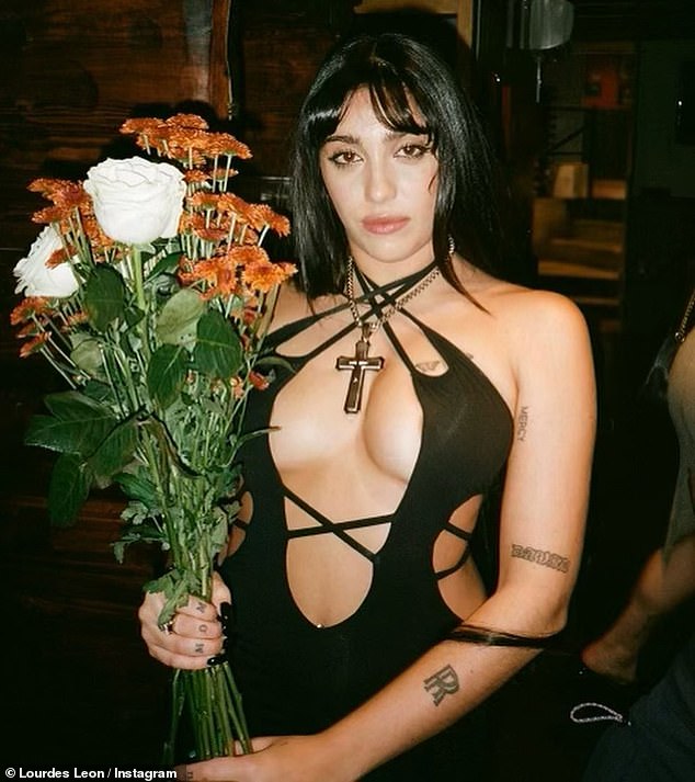 Beautiful: The model and singer posed with a bouquet of flowers, possibly in celebration of her birthday on Friday