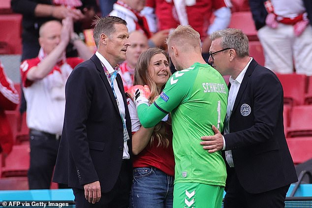 Denmark captain Simon Kjaer and goalkeeper Kasper Schmeichel (second right) embraced Eriksen's tearful partner Sabrina Kvist Jensen (second left) in a powerful, emotional moment