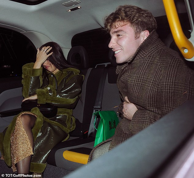 Stylish couple: Rocco's glamorous companion for the evening looked gorgeous in an olive green leather coat complete with fur trim