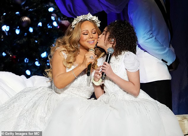 So sweet: Mariah brought out Monroe, 11, whom she shares with ex-husband Nick Cannon, to sing beloved Christmas carol 'Away in a Manger'